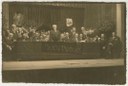 Simon Dubnow (standing, center) at the 1st international YIVO conference, Vilna, Poland. Other historians and notables on the stage and dais include (seated, from left) Joseph Tshernikhov, Elias Tcherikower, Yankev Botoshansky; (behind Botoshansky’s left shoulder) Zelig Kalmanovitch; (to Dubnow’s right) Ignacy Schiper; (behind Dubnow’s right shoulder) Rafail Abramovich; (seated, first to fourth from right) Yudl Mark, Yankev Shatzky, Max Weinreich, Zalmen Reyzen; (standing behind Weinreich), Nakhman Meisel. The portrait of Tsemaḥ Szabad (right) is draped in black in commemoration of his death, which had occurred a few months earlier.